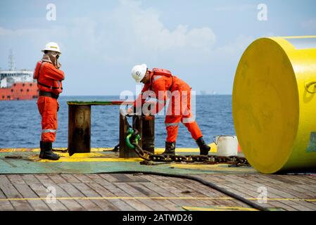 AHTS vessel marine crew carried out anchor handling operation on deck Stock Photo