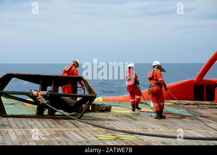 AHTS vessel marine crew carried out anchor handling operation on deck Stock Photo