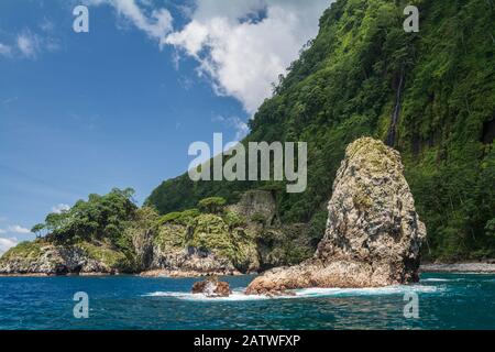 Rocks and coastal rainforest. Cocos Island National Park, Costa Rica. 2018. Stock Photo