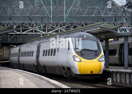 Alstom class 390 Pendolino high speed train in Avanti West Coast livery waiting at a station platform in the United Kingdom. Stock Photo