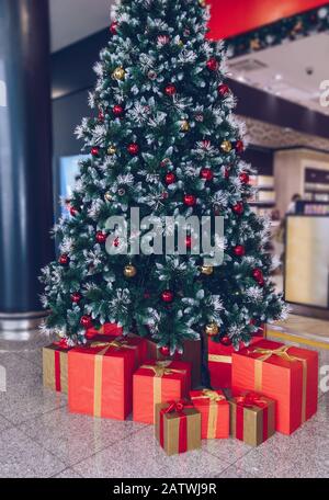 decorated christmas tree with red and gold gift boxes Stock Photo