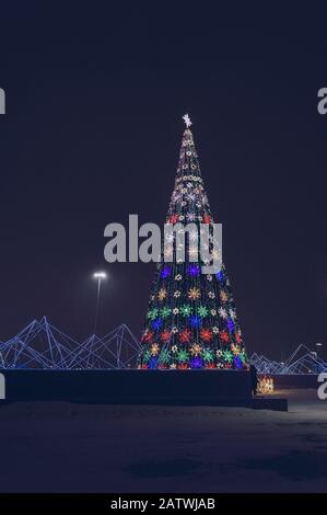 illuminted christmas tree in park of Nur Sultan at winter night Stock Photo