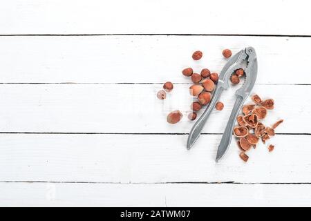 Nutcracker with Nuts. Hazelnut. On a wooden background. Top view. Copy space for your text. Stock Photo