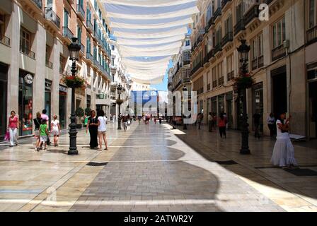 Shops and shoppers along the Calle Marques de Larios main shopping street in the city centre, Malaga, Malaga Province, Spain. Stock Photo