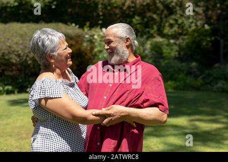 Senior couple looking at each other in the garden Stock Photo