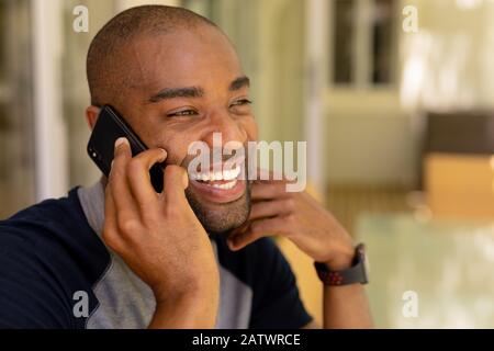 Young man talking on his mobile phone Stock Photo