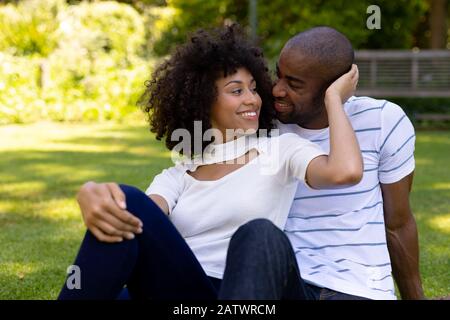 Happy young couple relaxing in the garden Stock Photo