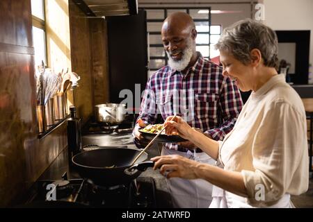 Old chefs cooking together Stock Photo