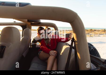Couple taking photos in a car Stock Photo