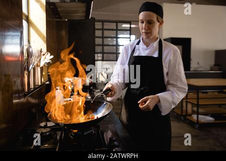 Caucasian chef cooking with fire Stock Photo