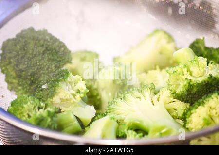 cooked broccoli draining in a metal sive Stock Photo