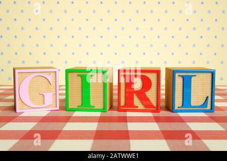 Childrens wooden ABC blocks spelling GIRL on a checked tablecloth Stock Photo