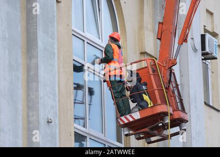 Window washer works on truck mounted lift Stock Photo