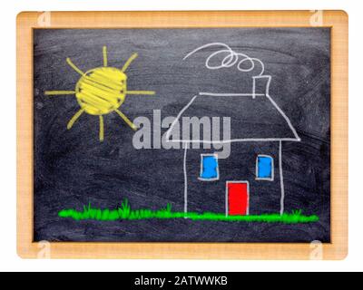 Childs drawing of a small house and sun on a small blackboard Stock Photo