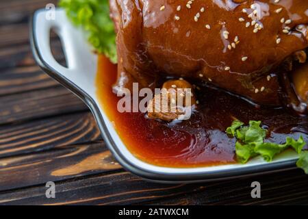 Roast pork knuckle served with boiled cabbage, bread, horseradish and mustard. Stock Photo