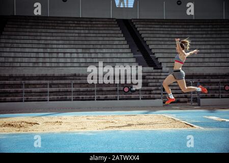 Athlete doing a long jump Stock Photo