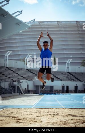 Athlete doing a long jump Stock Photo