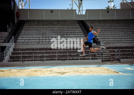 Athlete doing a long jump Stock Photo