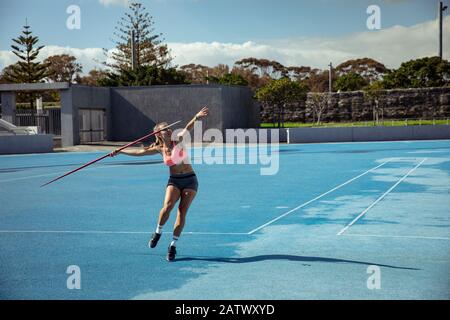 Athlete throwing a javelin at the stadium Stock Photo