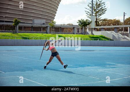 Athlete throwing a javelin at the stadium Stock Photo