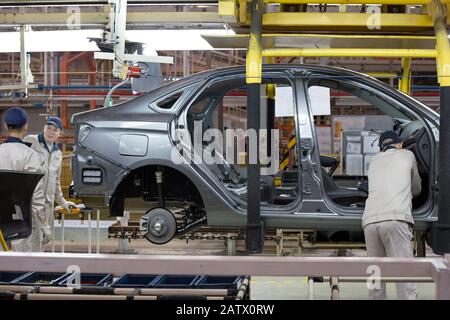 Russia, Izhevsk - December 14, 2019: LADA Automobile Plant Izhevsk. The workers are installing details on a new car. Assembly shop of automobile plant Stock Photo