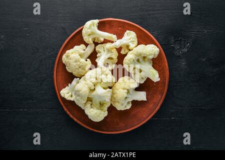 Cauliflower. On a black wooden background. Top view. Free space. Stock Photo