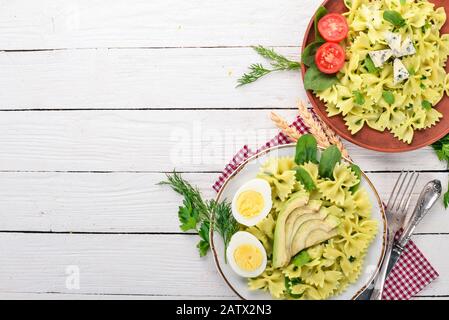 Pasta with spinach. On a wooden background. Top view. Copy space. Stock Photo