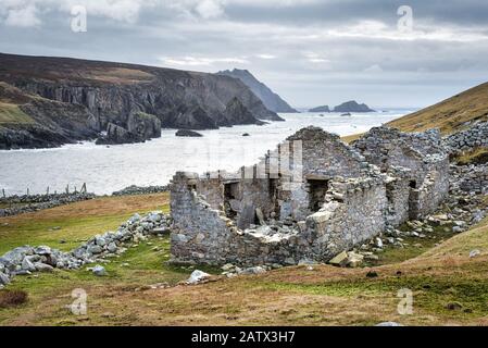 The ruins of an old famine stone built cottage on a remote part of the Irelands west coast in County Donegal Stock Photo
