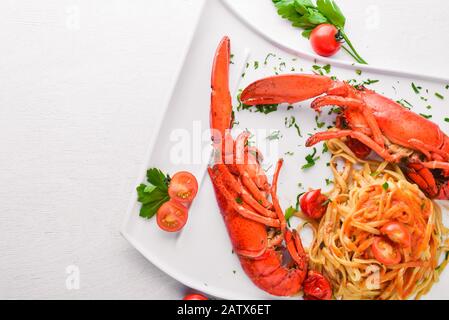 Omar boiled in spices and seafood pastes. On a wooden background. Top view. Free space for your text. Stock Photo