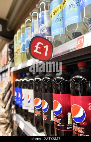 Bottles of pop for sale in a shop Stock Photo