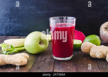 A glass with fresh homemade detox beetroot juice and ingredients Stock Photo