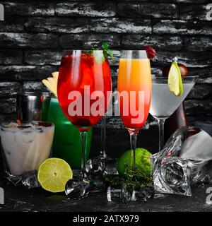 Set of colored alcoholic cocktails. On the black bar. Stock Photo