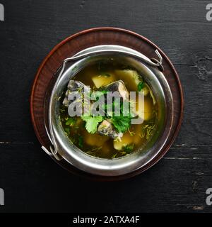 Trout fish soup. Ukrainian cuisine. Top view. Free space for your text. Rustic style. Stock Photo