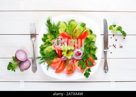 Fresh vegetables sliced in a plate. On the old background. free copying space. Stock Photo