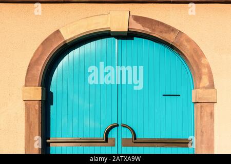 Blue wooden door on brick cement wall background Stock Photo