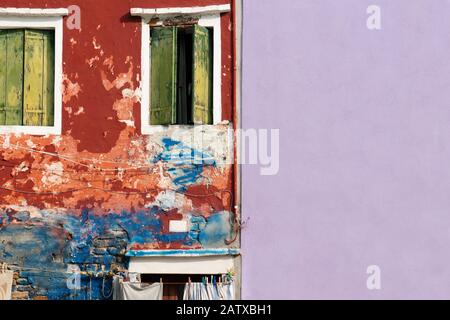 rugged and smooth wall with crack wooden window on colorful cement background Stock Photo