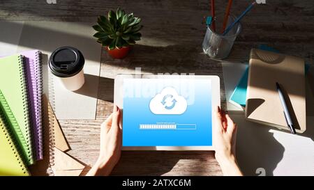 Cloud synchronization progress bar on tablet screen. Data storage and protection. Technology and internet concept Stock Photo