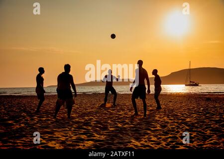 Silhouettes of people playing football on the beach in Elafonissos, Peloponnese, Greece Stock Photo