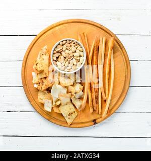 Salty appetizers for beer. Snacks and peanuts. Top view. Free copy space. Stock Photo