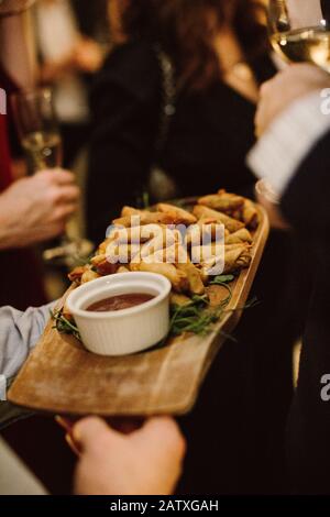 Close up of a platter of finger food being handed out at a city networking event / party Stock Photo