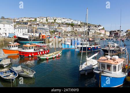 Mevagissey harbour with boats at anchor the village is within the Cornish Area of Outstanding Natural Beauty Stock Photo