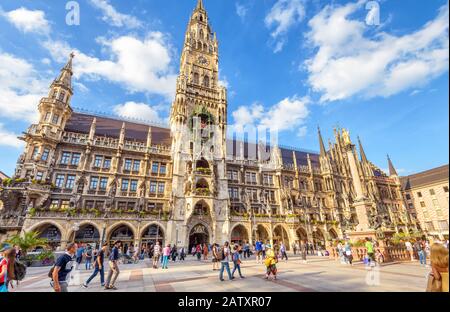 Munich, Germany – Aug 1, 2019: People visit Marienplatz square in Munich. Panorama of Town Hall or Rathaus in summer. It is a famous Gothic landmark o Stock Photo