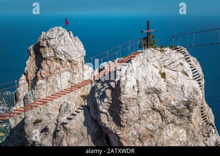 Rock on the Mount Ai-Petri with a rope bridge in Crimea, Russia. It is one of the highest mountains in Crimea and tourist attraction. 'Save and Protec Stock Photo