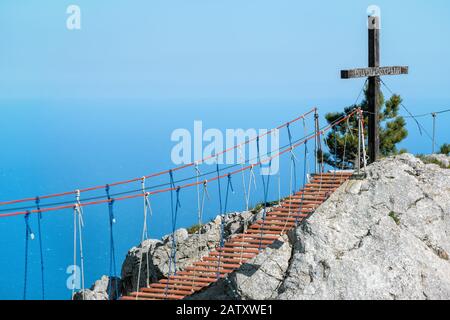 The rope bridge on the Mount Ai-Petri in Crimea, Russia. It is one of the highest mountains in the Crimea and tourist attraction. 'Save and Protect' o Stock Photo