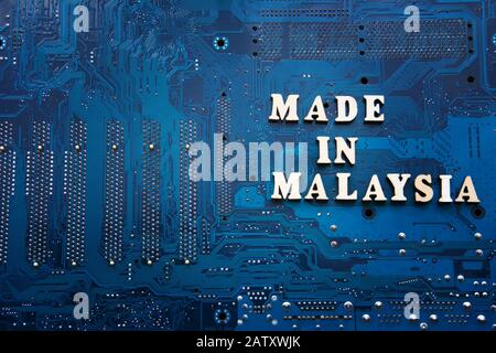 Inscription Made in Malaysia on a blue electronic printed circuit board. Background with copyspace for design. Malaysia electronics industry concept Stock Photo