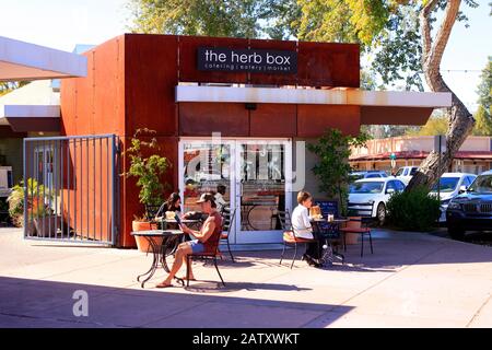 People sitting outside the Herb Box cafe in the 5th Avenue shopping district of Old Town Scottsdale AZ Stock Photo