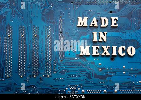 Made in Mexico. Inscription on a blue printed circuit board background. Copyspace for design Stock Photo