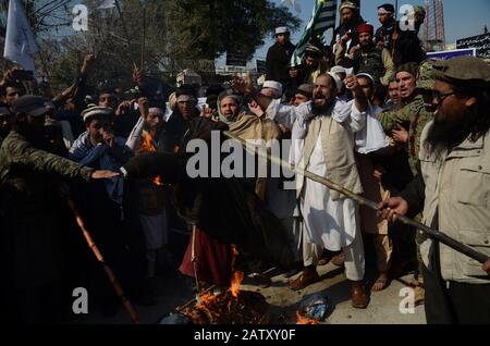 February 5, 2020: Peshawar, Pakistan. 05 February 2020. Pakistanis stage a protest to mark Kashmir Solidarity Day, in the Pakistani city of Peshawar. Participants waved banners and chanted slogans in support of India administered Kashmir and Kasmiris' struggle for their right to self-determination. The Indian flag and an effigy of Indian President Narendra Modi were set alight during the protest on Wednesday. Children also joined the rally waving Pakistan and the Azad Jammu and Kashmir flag in solidarity with the Kashmiris. The Indian State of Jammu and Kashmir has been under severe restrict Stock Photo