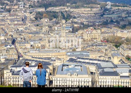 People taking advantage of the high vantage point view are pictured in Alexandra Park looking down at the city of Bath. Bath Somerset England uk Stock Photo