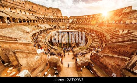 Inside the Colosseum or Coliseum in summer, Rome, Italy. Colosseum is the main travel attraction of Roma. Tourists visit the Colosseum. Panoramic view Stock Photo